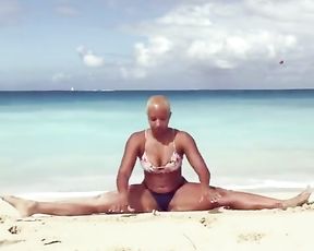 Curvy girl does sexy yoga on the beach