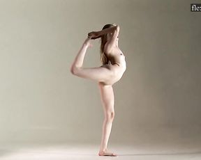 Nude teen gymnast Sofia warming up with naked yoga exercises