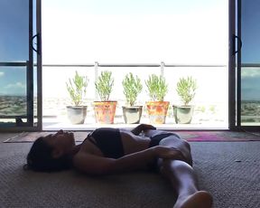 Sexy video blogger warms up having hot yoga session at home