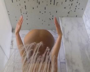 Sexy mature lady in see-through bodysuit doing yoga in the shower