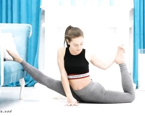 Hot gymnast in tight yoga pants does sexy flexible exercises