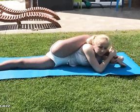 Hot professional gymnast does outdoor yoga exercises
